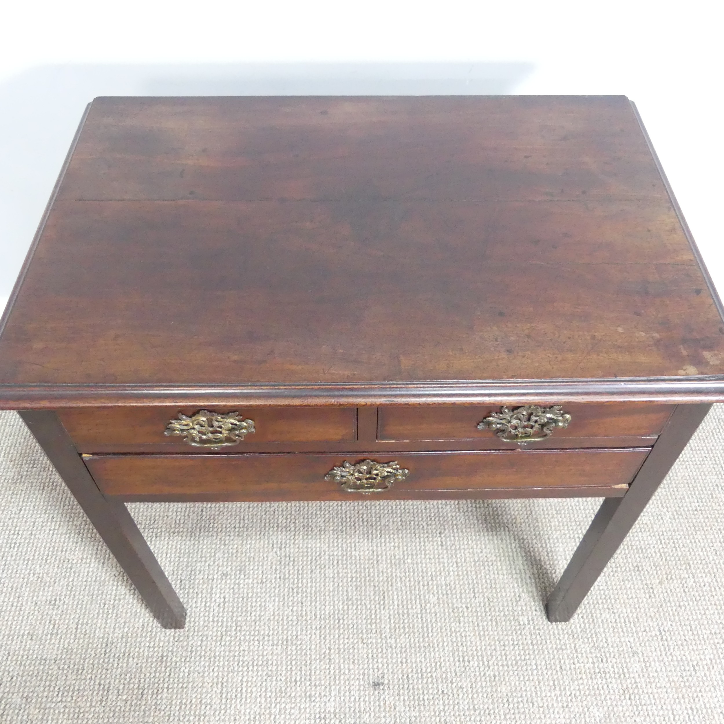 A Georgian oak Lowboy, shaped top over three drawers and square canted legs, W 75.5 cm x H 71 cm x D - Image 2 of 6