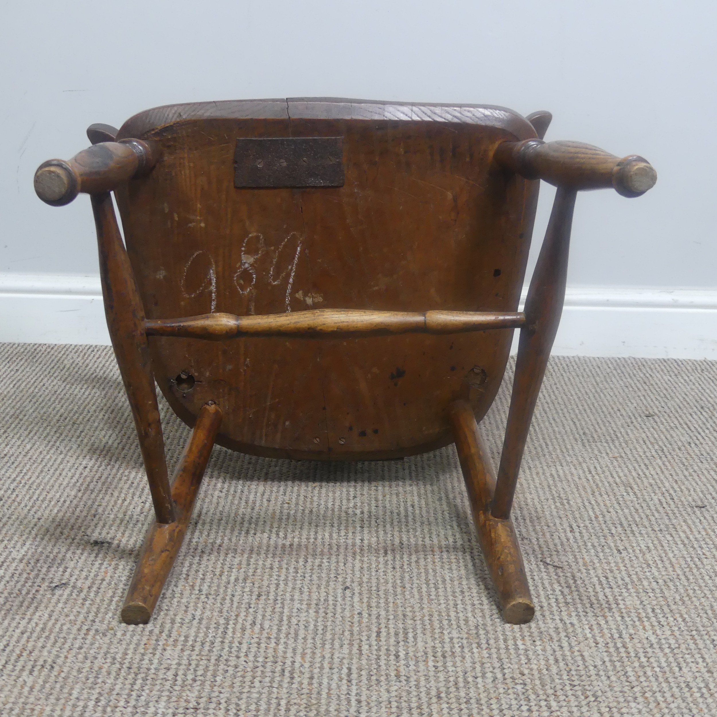 An antique ash and elm windsor Armchair, legs cuts down and with old metal repairs, W 57 cm x H 85 - Image 8 of 8