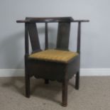 A Georgian mahogany corner elbow Chair, raised on square supports, W 76 cm x H 83.5 cm x D 62 cm.