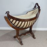 An unusual Regency mahogany swing Cradle / Crib, circa 1820, of navette form with slatted sides