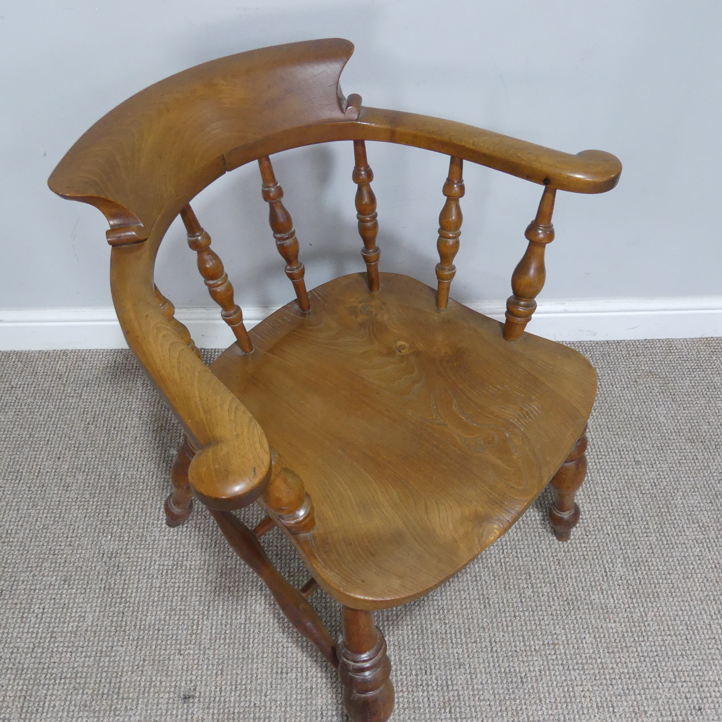 An early 20th century ash and elm Captains / Smokers Bow Armchair, W 66 cm x H 77 cm x D 60 cm. - Image 2 of 4