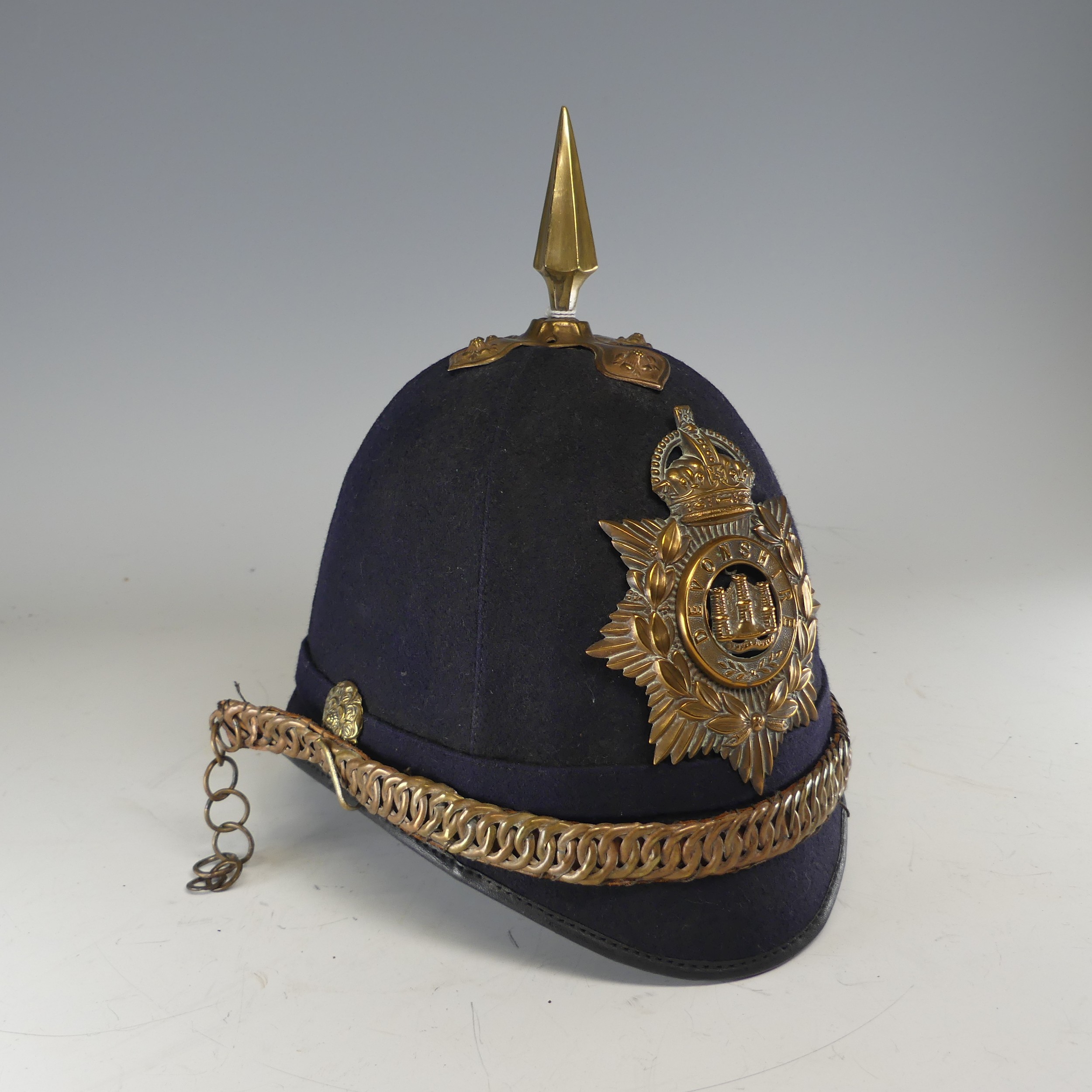 A Devonshire Regiment Officer’s Blue Cloth Helmet, 1902-14 style, together with a Victorian style