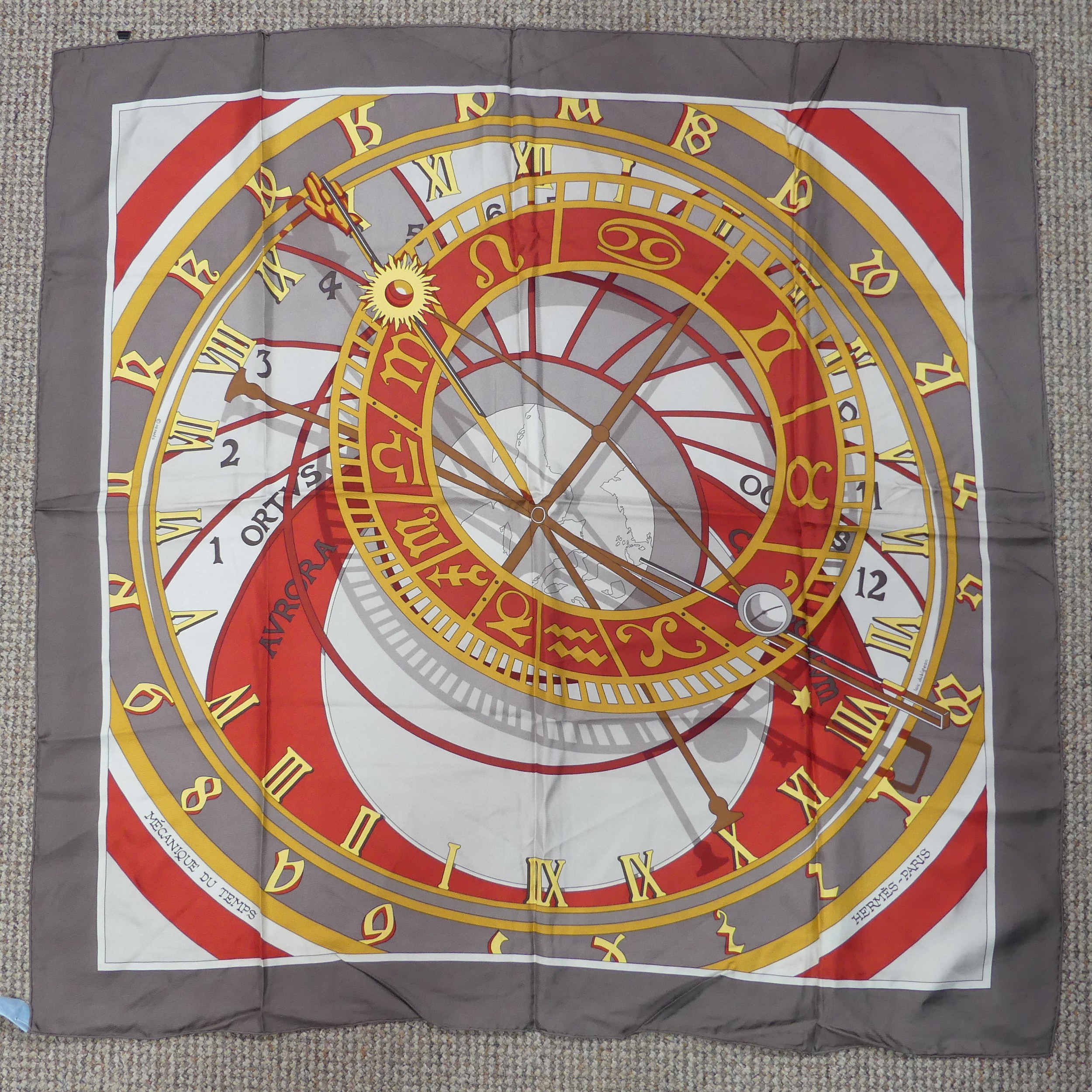 A Hermès silk twill scarf: 'Mecanique du Temps', designed by Loic Dubigeon on taupe ground, hand