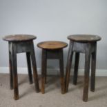 Three antique stained pine kitchen Stools, with oval tops and pierced handles, raised on chamfered