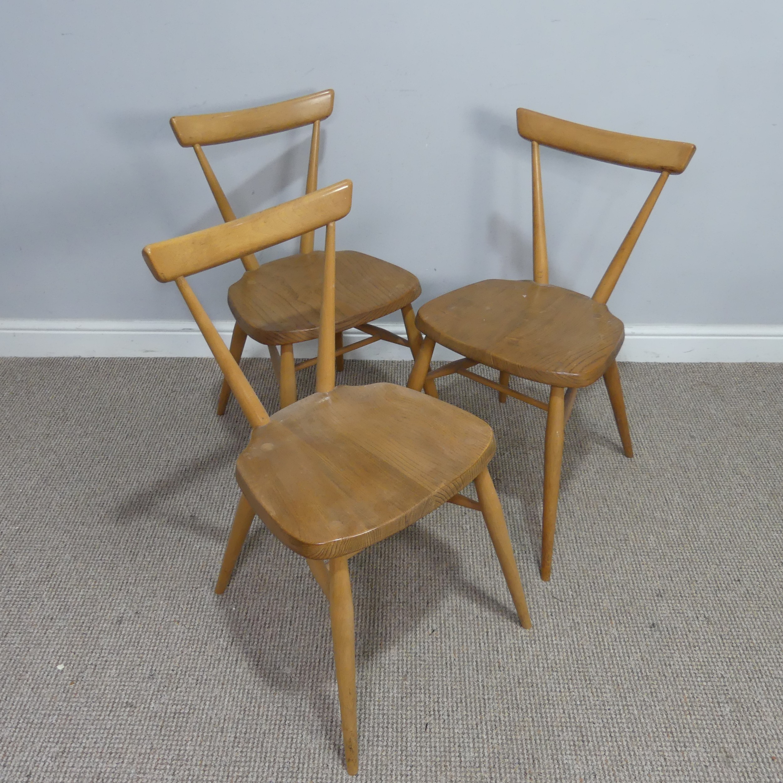 A set of three mid 20th century Ercol stacking Chairs, single slat backs over shaped seats and