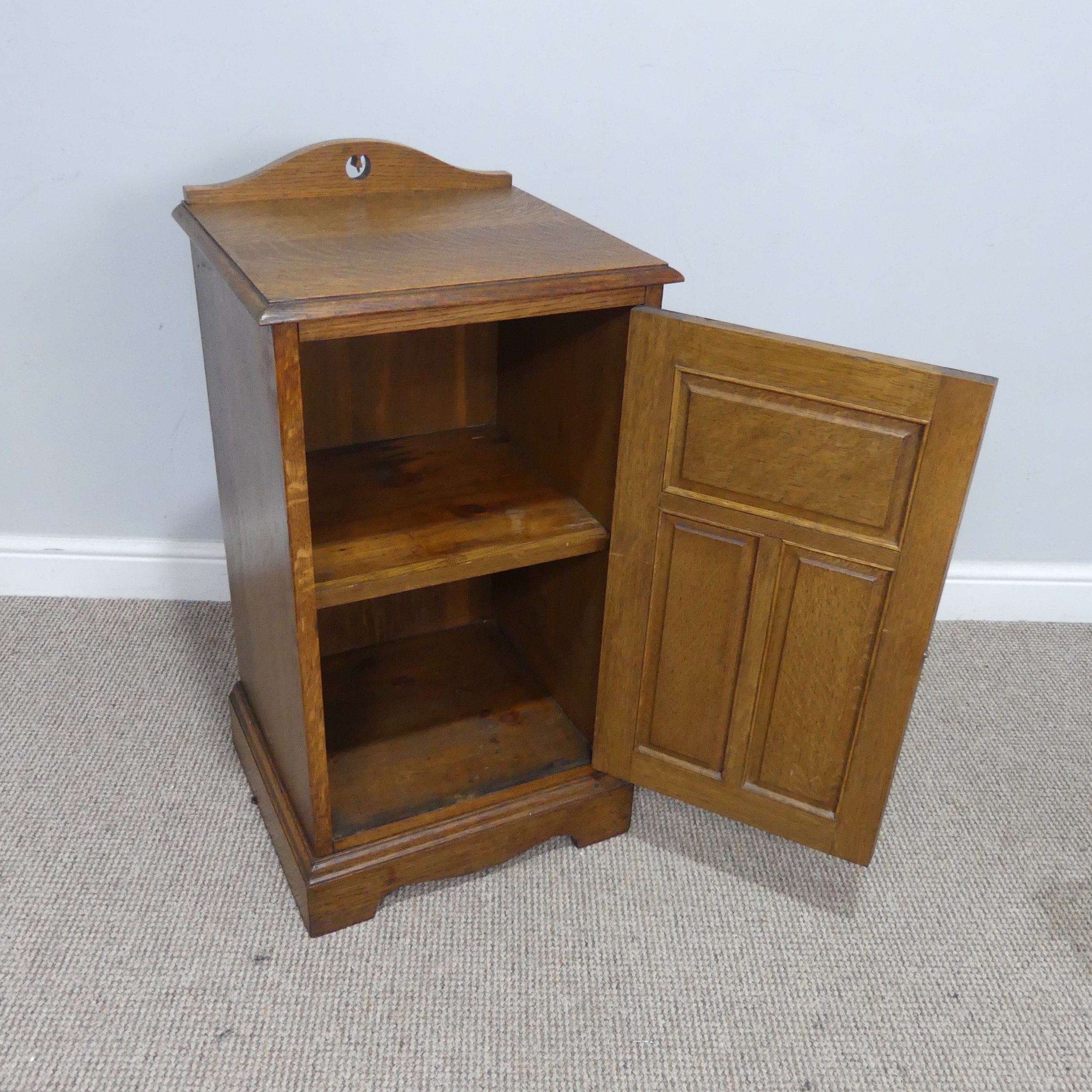 An Arts and crafts oak bedside Cabinet, pierced top over panelled doors, raised on shaped plinth - Image 3 of 3