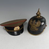 A Prussian style Pickelhaube military Helmet, with a brass spread eagle inscribed Mit Gott fur