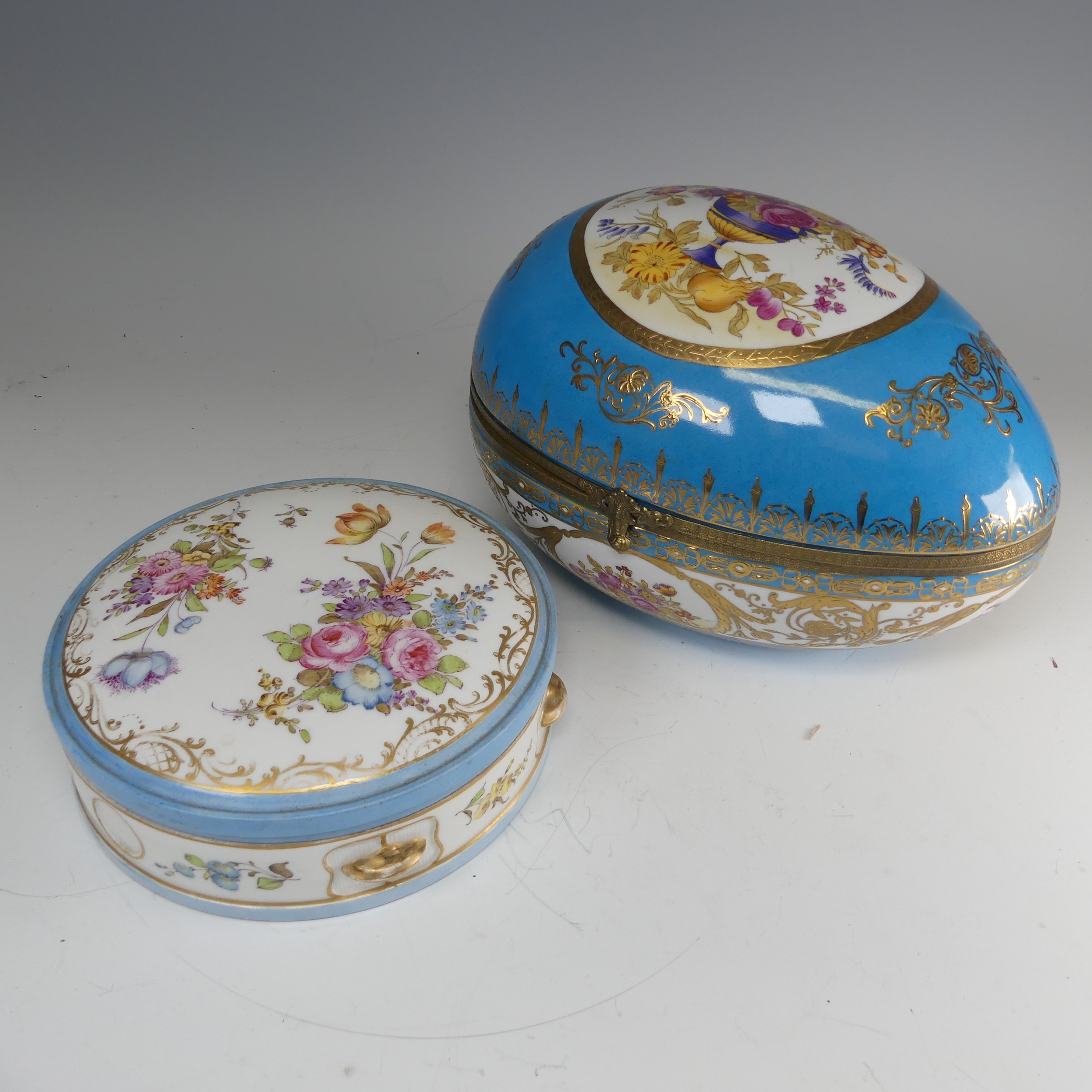 A continental porcelain Sevres style egg shaped Box, blue ground with gilt metal mount, decorated