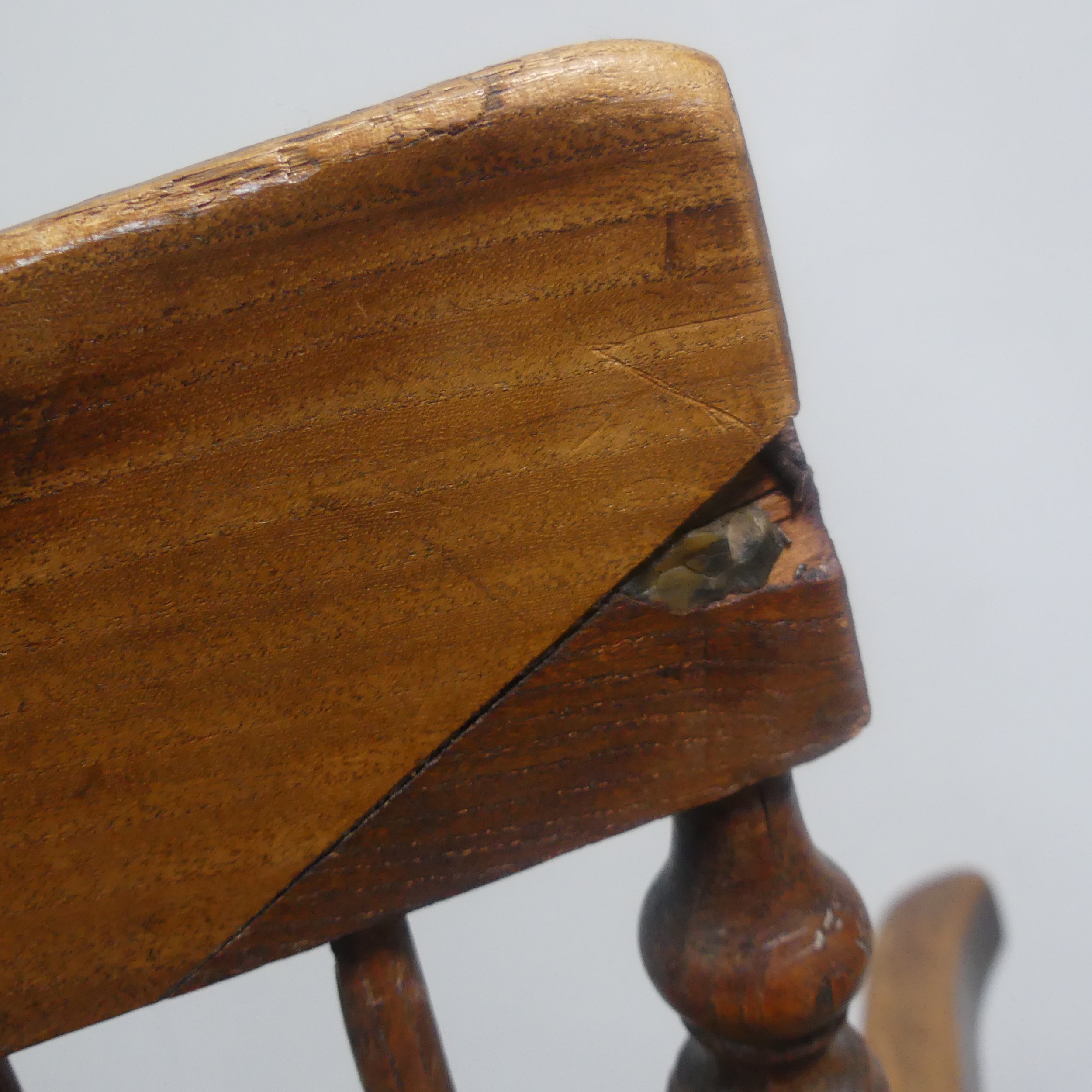 An antique ash and elm windsor Armchair, legs cuts down and with old metal repairs, W 57 cm x H 85 - Image 5 of 8