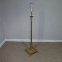 An antique brass standard Lamp, electrified, with corinthian column raised on stepped base and