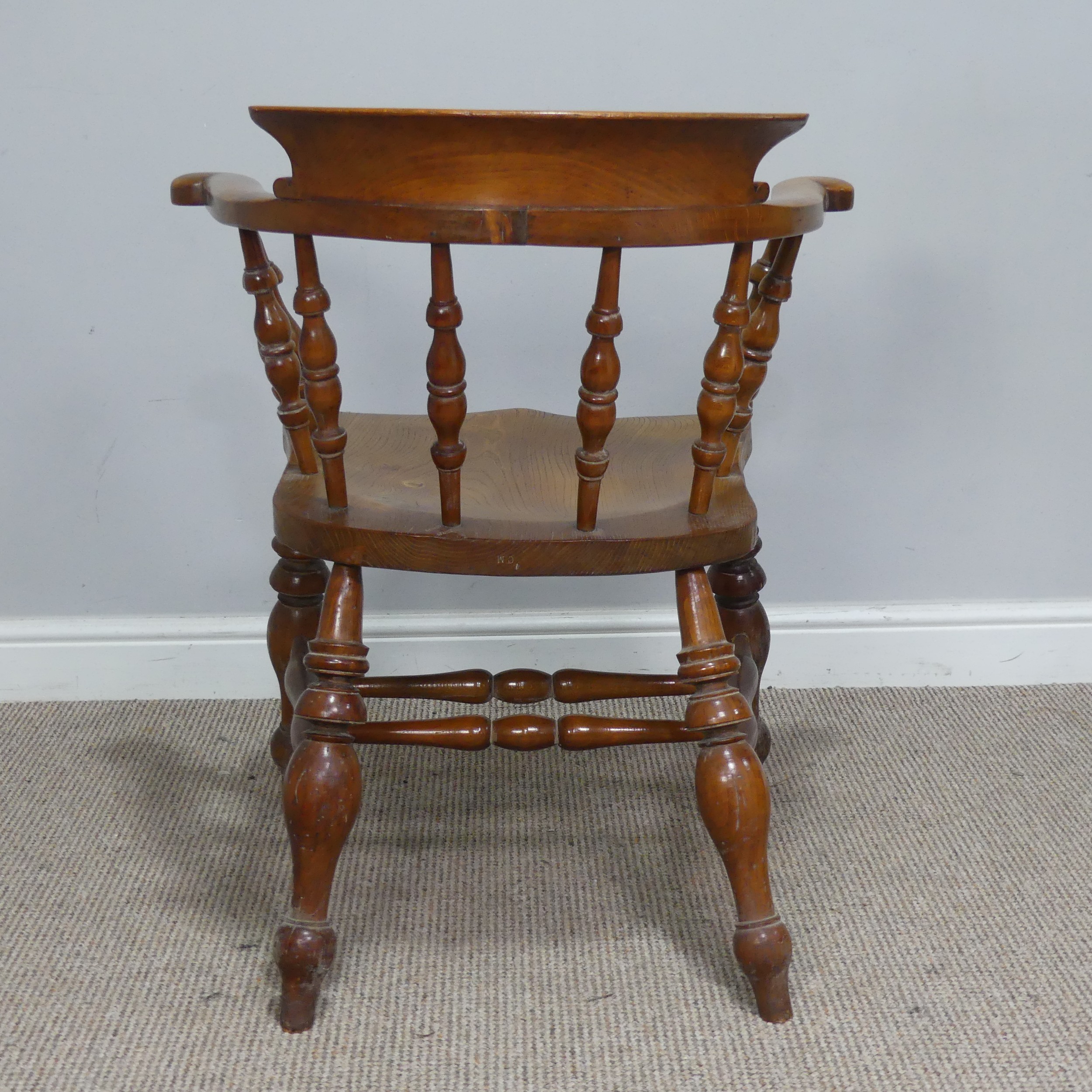 An early 20th century ash and elm Captains / Smokers Bow Armchair, W 66 cm x H 77 cm x D 60 cm. - Image 4 of 4