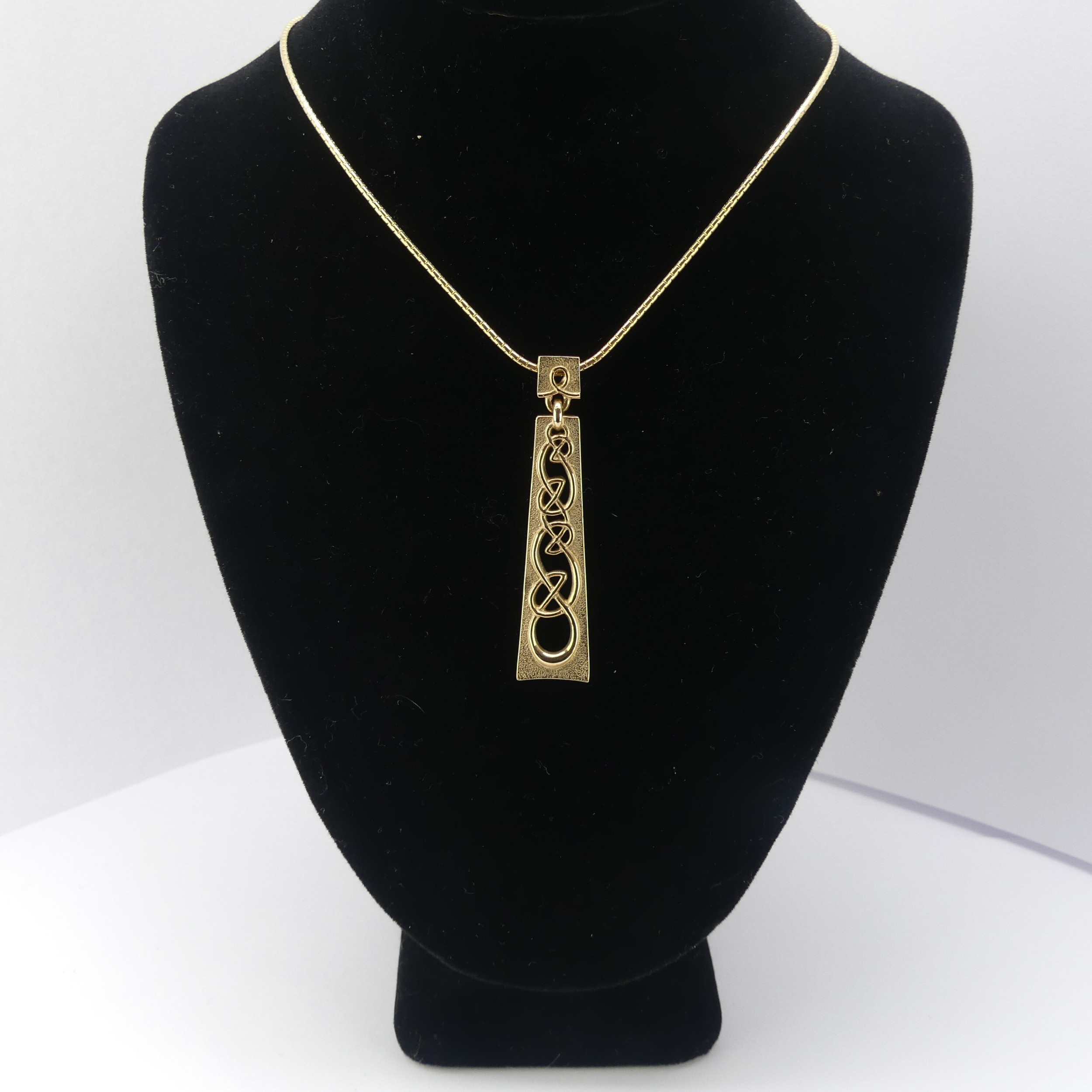 Ola Gorie; a Scottish 9ct yellow gold Pendant, the plaque pierced with Celtic design, 4.5cm long, on