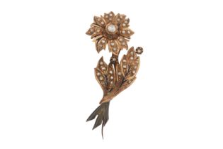 A 9CT GOLD DIAMOND SET FLOWER BROOCH