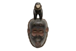 A GABON MBULU CARVED AND PAINTED WOOD MONKEY MASK