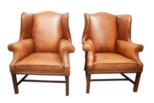 A PAIR OF GEORGIAN STYLE TAN LEATHER WINGBACK ARMCHAIRS