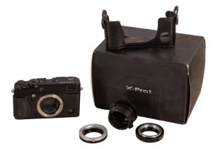A Fuji X-Pro 1 Digital Mirrorless Rangefinder Camera with Various Lens Adapters