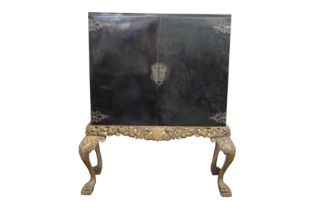 A 19TH CENTURY BLACK LACQUERED CABINET ON GILTWOOD STAND