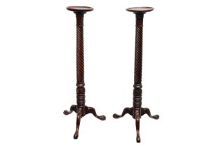 A PAIR OF MAHOGANY TORCHERES