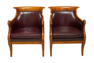 A PAIR OF EMPIRE STYLE FIGURED BEECH LIBRARY ARMCHAIRS