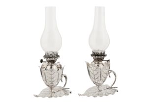 A pair of Victorian sterling silver oil lamp chambersticks, Birmingham 1892 by Hukin and Heath, one