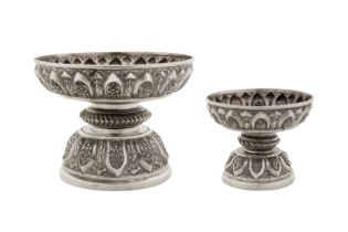 A graduated pair of early 20th century Cambodian unmarked silver dish on stands (tok), circa 1930