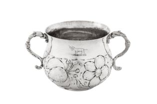 A Charles II sterling silver porringer, London 1677 by TH above a rosette (unidentified)