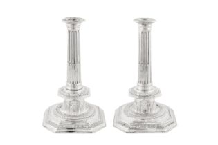 A large pair of Queen Anne Britannia standard silver candlesticks, London 1705 by John Barnard I