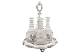 A Victorian sterling silver four bottle decanter stand, London 1842 by John and Henry Lias