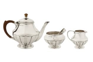 A George V ‘Arts and Crafts’ sterling silver three-piece tea service, Birmingham 1927 by William Hai