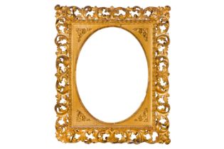 A FLORENTINE 19TH CENTURY CARVED, PIERCED, SWEPT AND GILDED FRAME