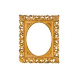 A FLORENTINE 19TH CENTURY CARVED, PIERCED, SWEPT AND GILDED FRAME