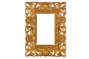 A FLORENTINE 19TH CENTURY CARVED, PIERCED, SWEPT AND GILDED FRAME