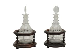 A PAIR OF GEORGIAN MASONIC DECANTERS AND BOBBIN TURNED STANDS