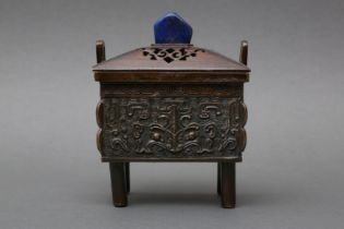 A CHINESE BRONZE CENSER AND COVER WITH LAPIS LAZULI FINIAL 清十八至十九世紀 銅饕餮紋青金岩鈕方鼎