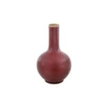 A CHINESE MONOCHROME COPPER RED-GLAZED VASE 清十九世紀 紅釉瓶