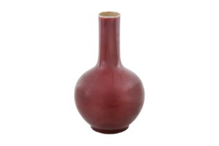 A CHINESE MONOCHROME COPPER RED-GLAZED VASE 清十九世紀 紅釉瓶