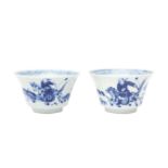 TWO CHINESE BLUE AND WHITE CUPS 清康熙 青花策馬勇戰圖盃兩件 《玉》款