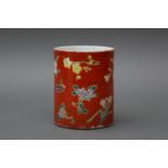 A CHINESE FAMILLE-ROSE CORAL-GROUND 'BLOSSOMS' BRUSH POT, BITONG 清十八至十九世紀 粉彩珊瑚紅地花卉紋筆筒