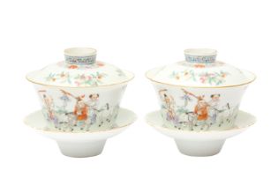 A PAIR OF CHINESE FAMILLE-ROSE CUPS, COVERS AND STANDS 民國時期 粉彩嬰戲圖蓋盌一對 《麟指呈祥》款
