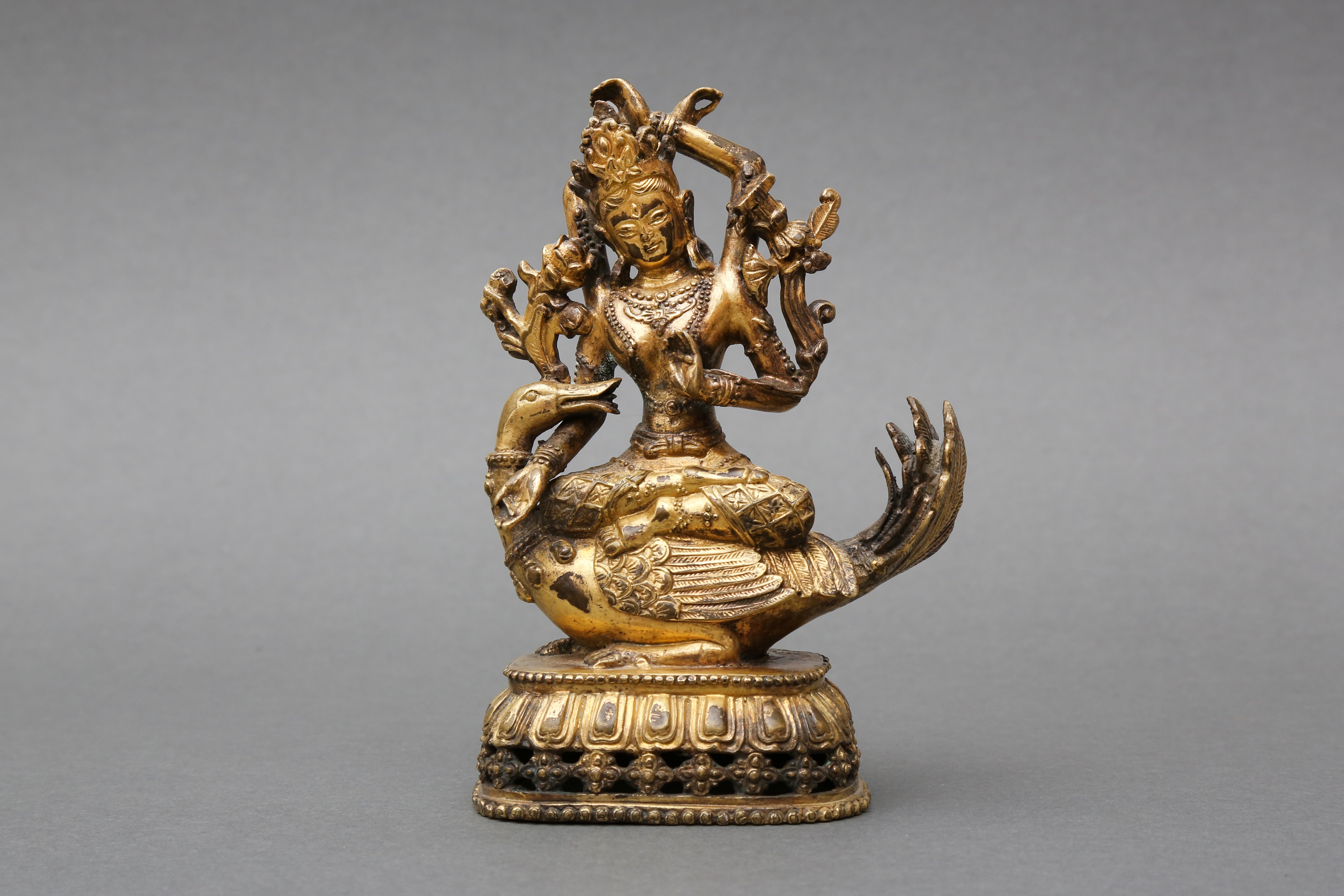 A SINO-TIBETAN GILT-BRONZE FIGURE OF A FOUR-ARMED BODHISATTVA 十九世紀或後期 四手佛像