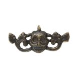 A SMALL HIMALAYAN BRONZE 'SKULL' AMULET