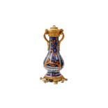 A CHINESE CLOBBERED BLUE AND WHITE ORMOLU-MOUNTED VASE 清康熙 青花加彩花卉紋瓶嵌鎏金銅飾