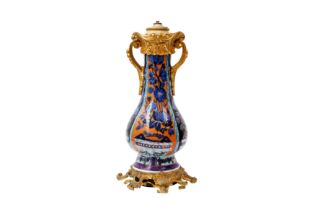 A CHINESE CLOBBERED BLUE AND WHITE ORMOLU-MOUNTED VASE 清康熙 青花加彩花卉紋瓶嵌鎏金銅飾