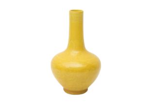 A SMALL CHINESE MONOCHROME YELLOW-GLAZED 'DRAGON' VASE 清十八世紀 黃釉暗刻龍紋瓶