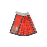 A CHINESE SILK EMBROIDERED RED-GROUND SKIRT 十九世紀 紅地緞繡花卉紋裙