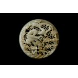 A CHINESE RETICULATED WHITE AND RUSSET JADE 'DRAGON' ROUND PLAQUE 十九世紀 白玉糖色龍趕珠紋珮