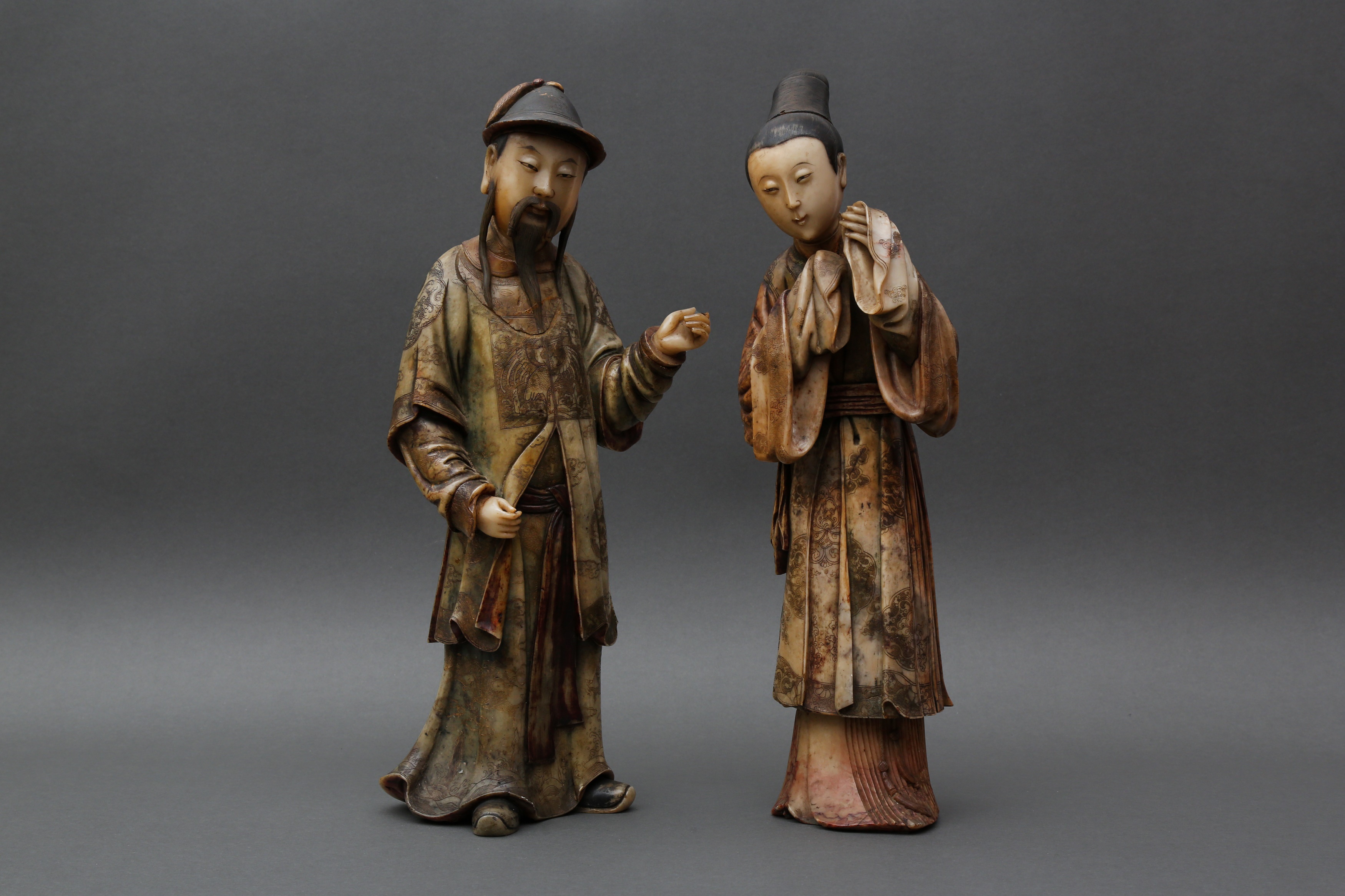 TWO RARE AND IMPRESSIVE CHINESE SOAPSTONE STANDING COURT FIGURES 清十八世紀 壽山石清廷人物像兩件