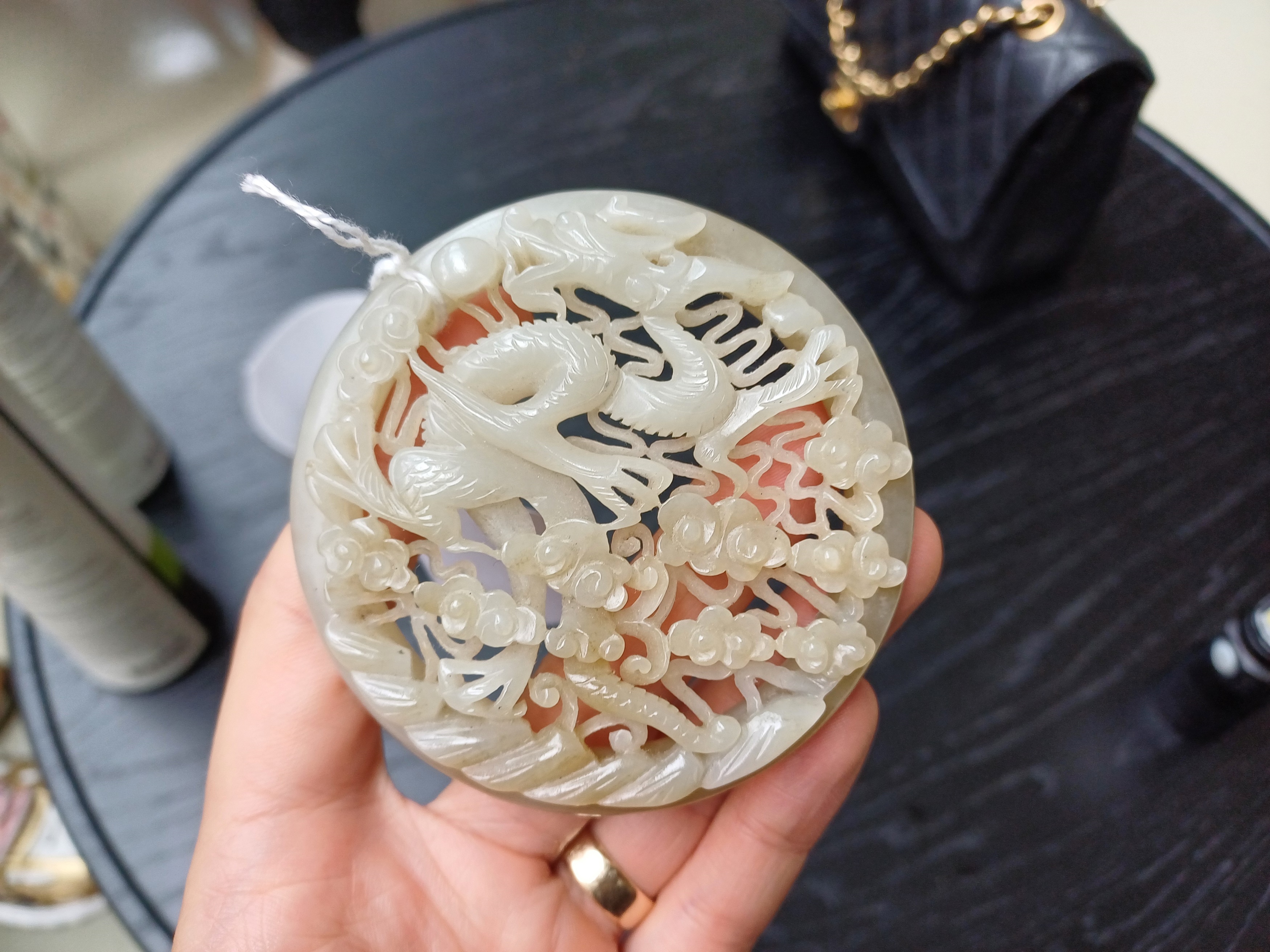A CHINESE RETICULATED WHITE AND RUSSET JADE 'DRAGON' ROUND PLAQUE 十九世紀 白玉糖色龍趕珠紋珮 - Image 3 of 10
