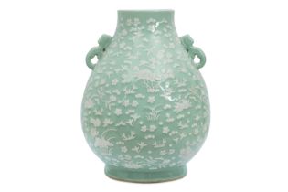 A LARGE CHINESE SLIP-DECORATED CELADON VASE, HU 青釉飾堆白雙龍耳瓶