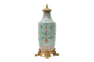 A CHINESE GILT-MOUNTED FAMILLE-ROSE TURQUOISE-GROUND 'LOTUS' VASE 清十九世紀 粉彩綠松石地蓮紋嵌鎏金銅飾瓶